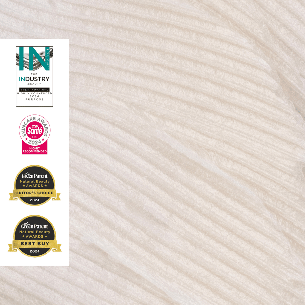 Closeup of lip balm texture with awards on a white background