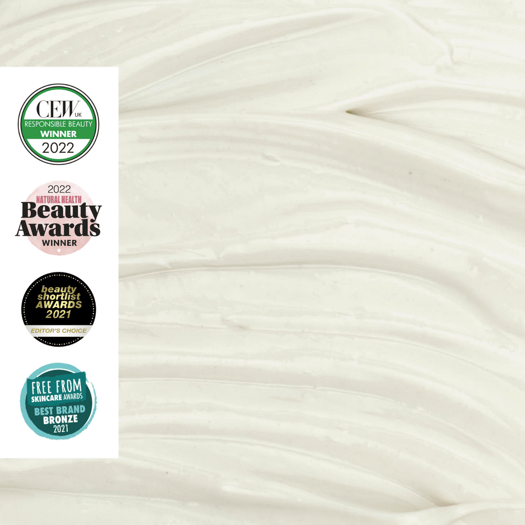 Close-up of moisturizer texture with multiple awards logos on a white background