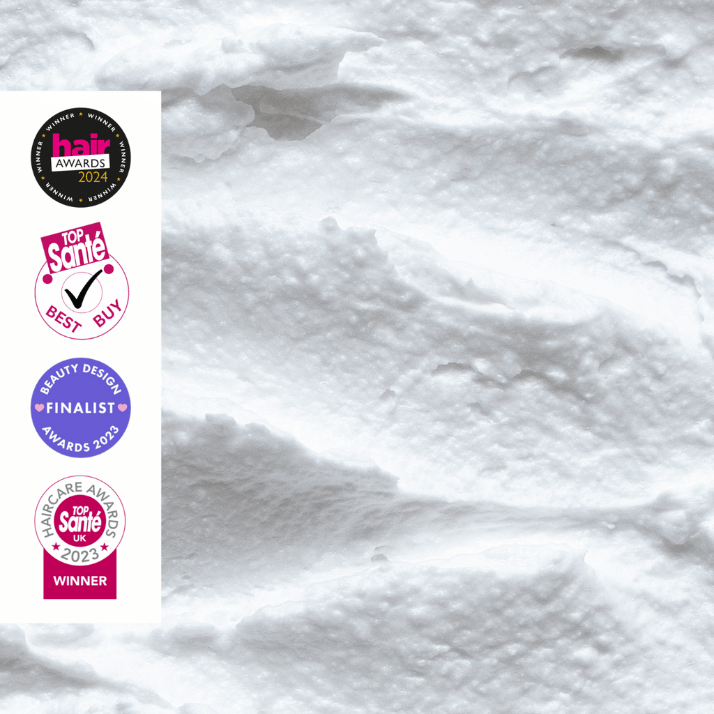 White textured shampoo creme by UpCircle with multiple awards logos on a white background