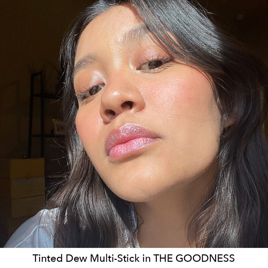 Close-up of a person with text 'Tinted Dew Multi-Stick in THE GOODNESS' at the bottom.
