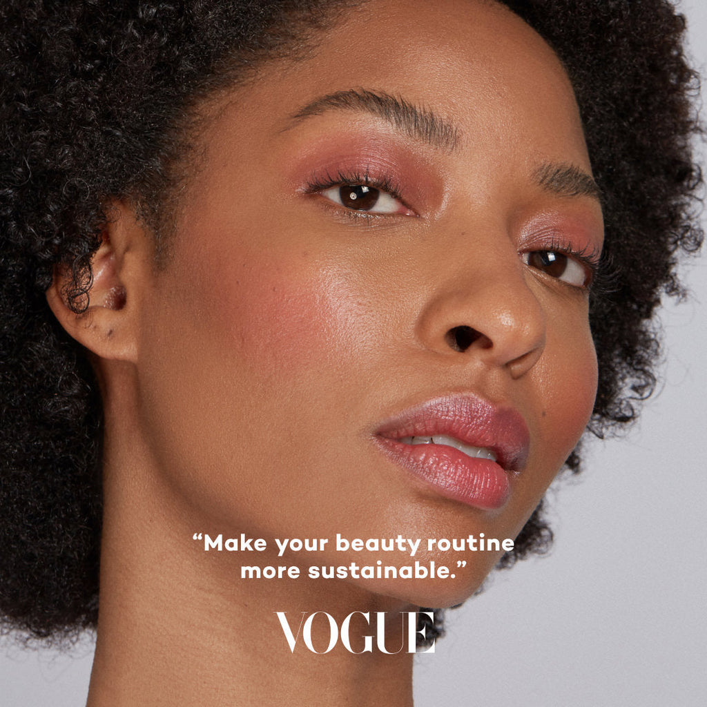 Close-up of a woman's face with makeup, featuring the Vogue logo and text.