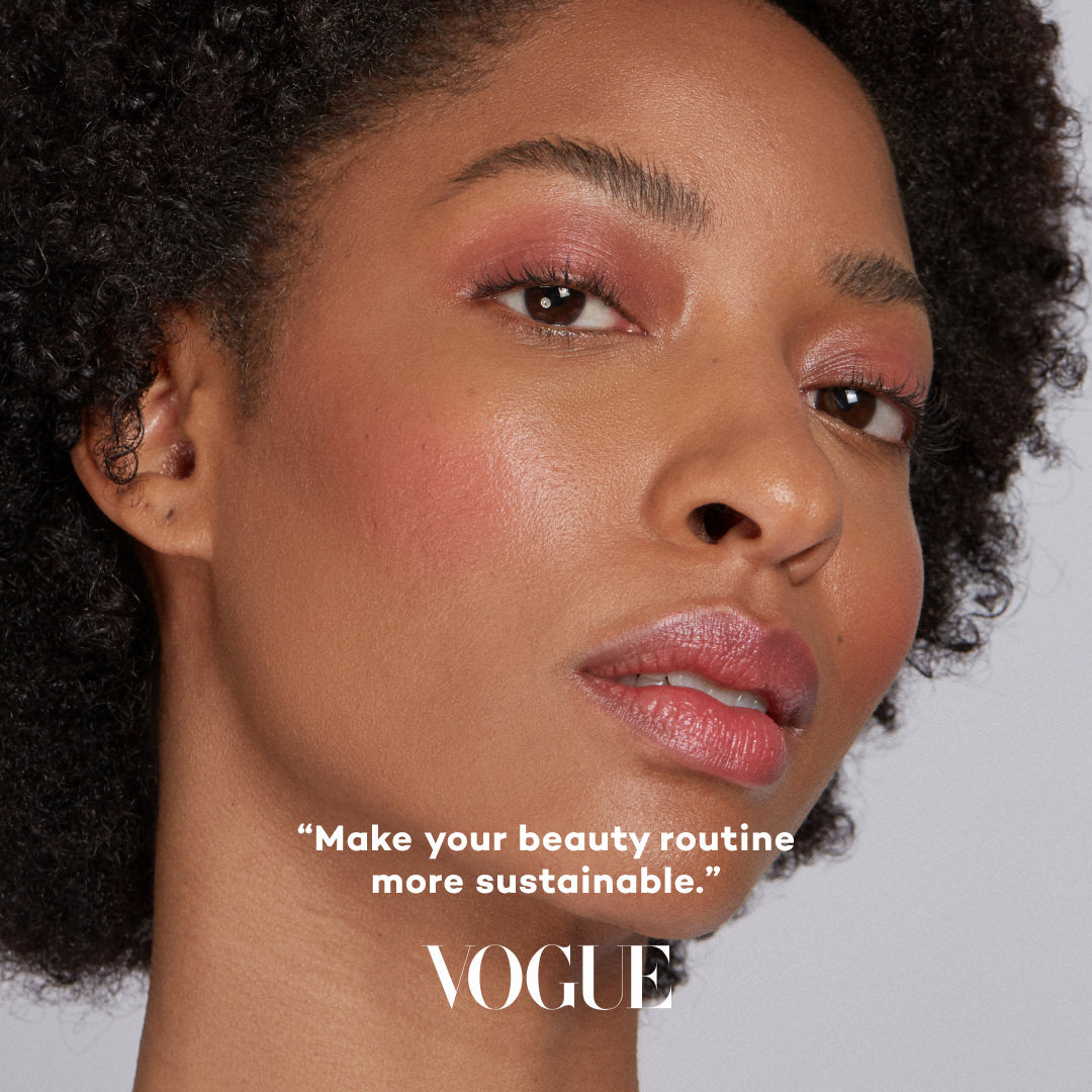 Close-up of a woman's face with makeup, featuring the Vogue logo and text.