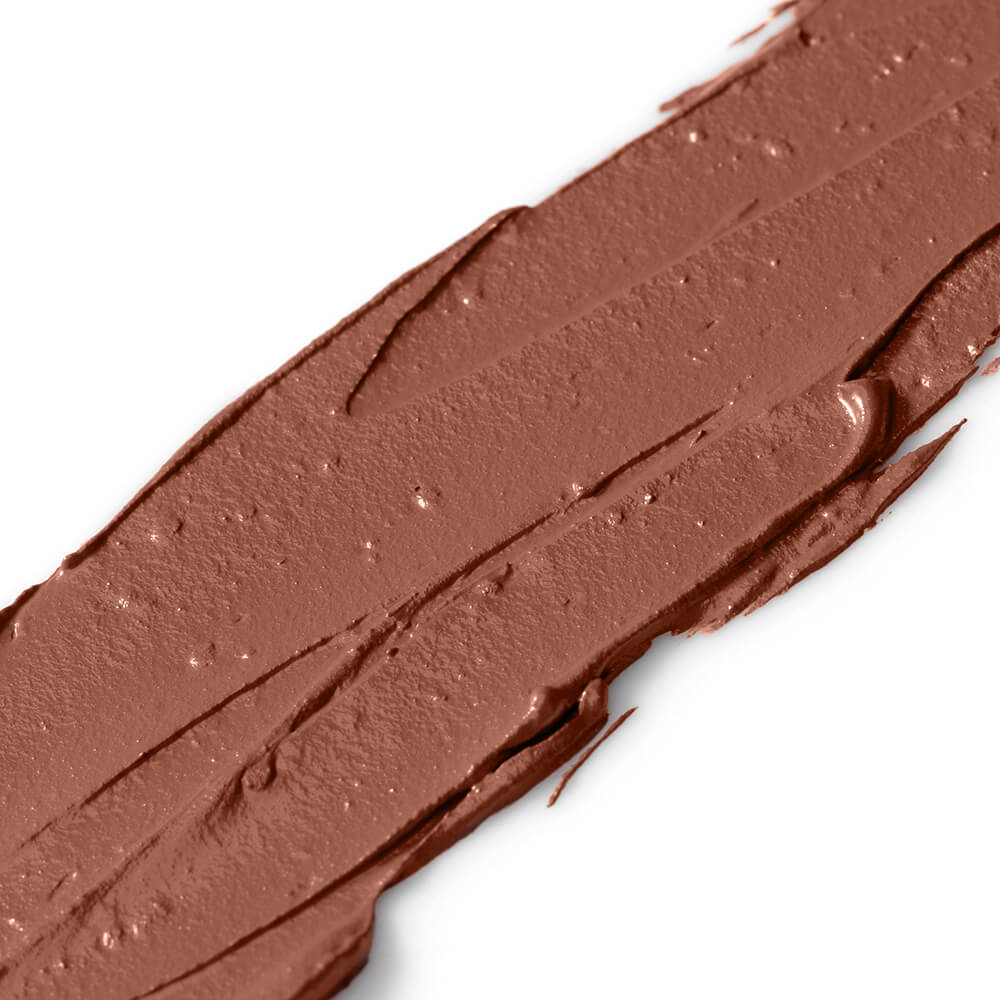 Close-up of a brown makeup swatch on a white background