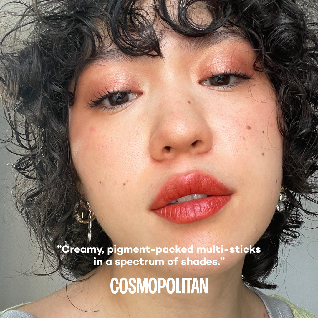 Close-up of a person wearing makeup with text overlay by Cosmopolitan about product.