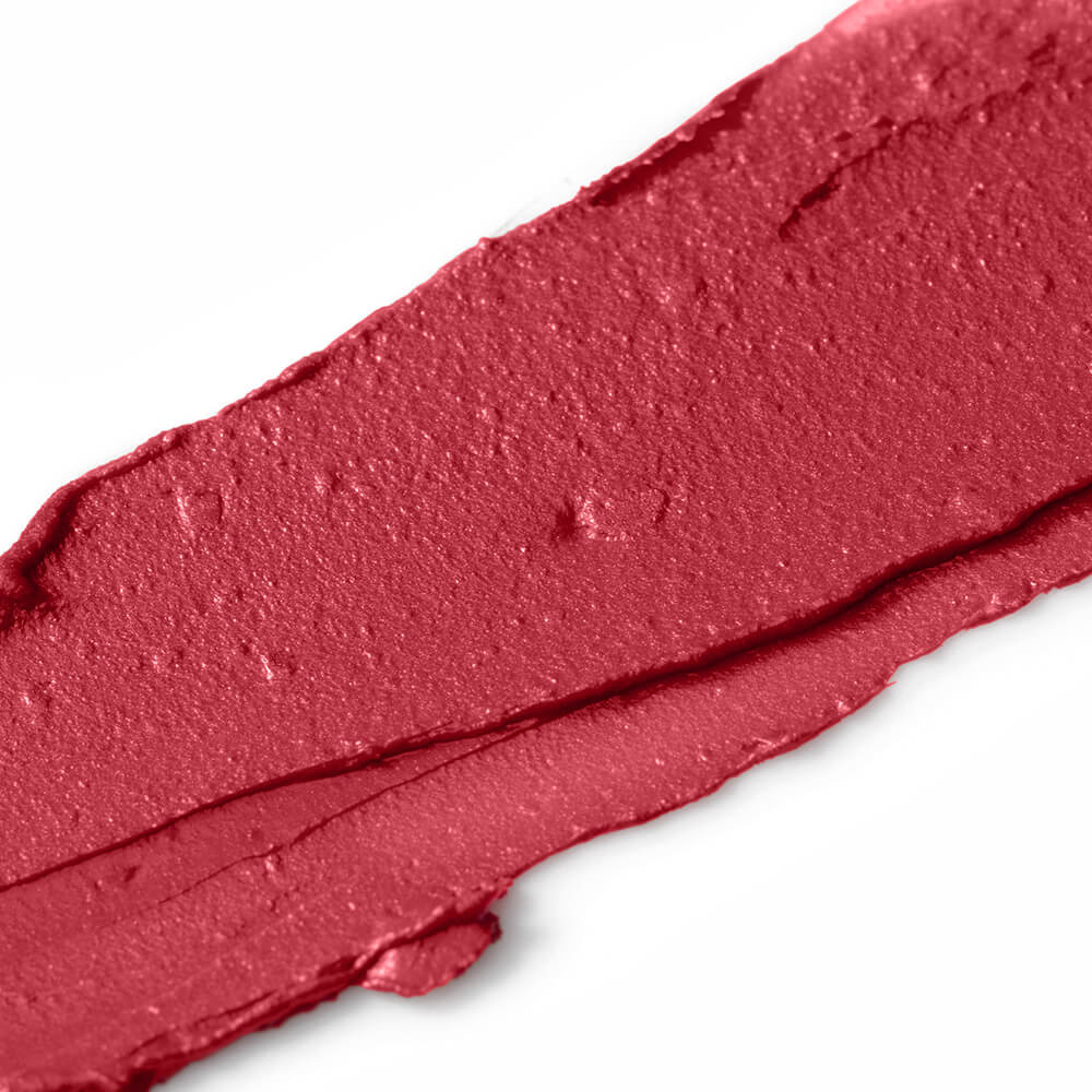 Close-up of a swatch of red lipstick on a white background