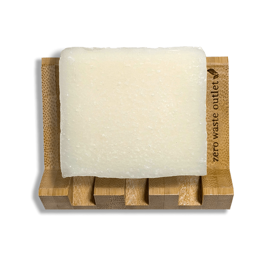 Bar of soap on a bamboo soap dish with 'zero waste outlet' branding.