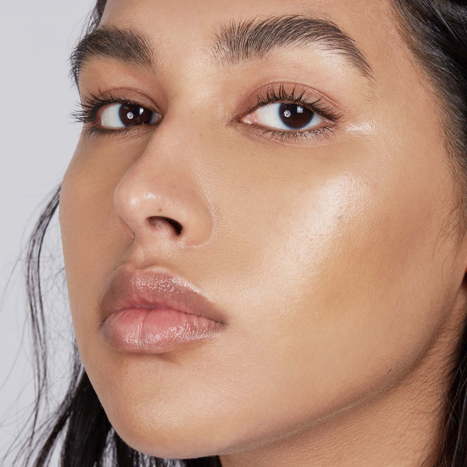 Close-up of a woman's face with a neutral background
