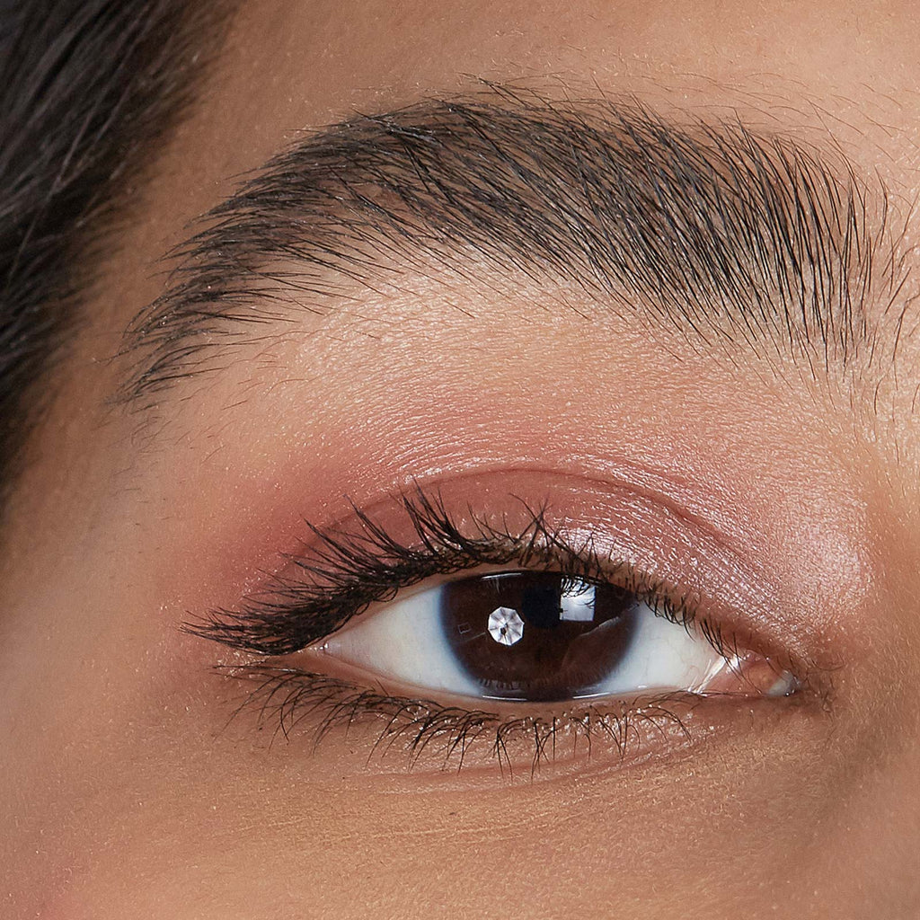 Close-up of a person's eye with makeup, focusing on the eyelid and eyebrow.