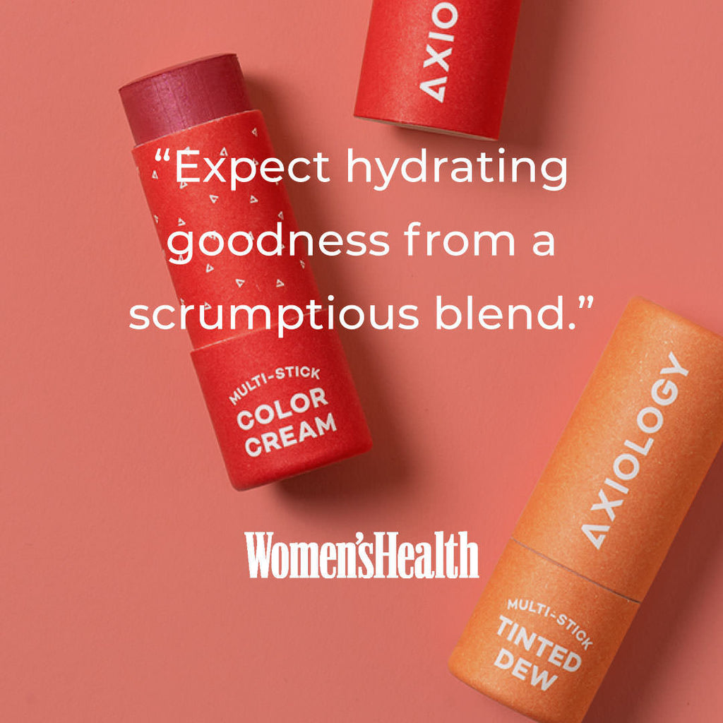 Two Axiology multi-stick color creams on a pink background with text and Women's Health logo.