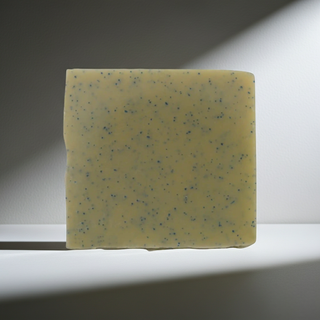 Yellow speckled soap bar on a white surface with a dark background