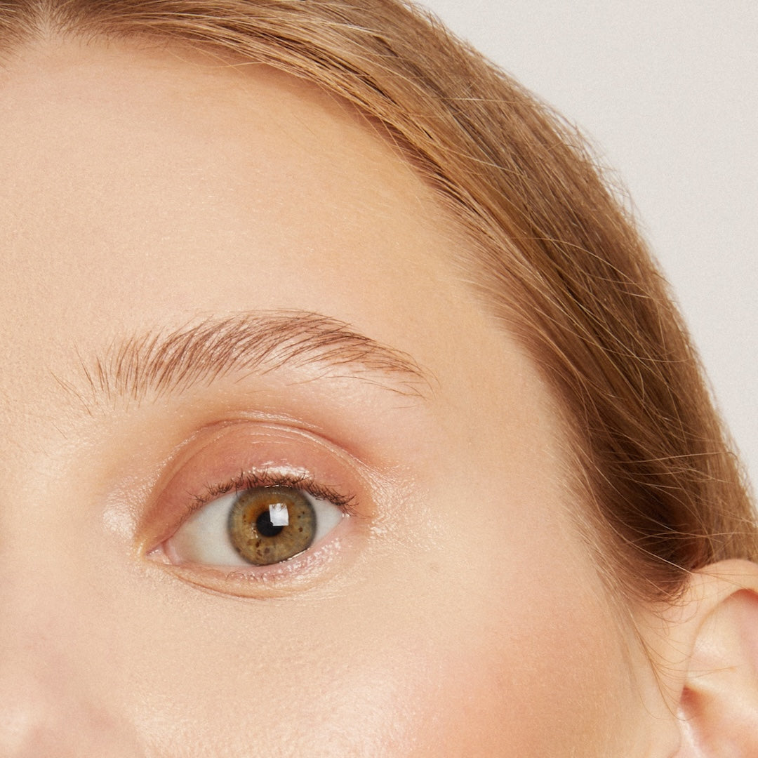 Close-up of a person's eye with a neutral background