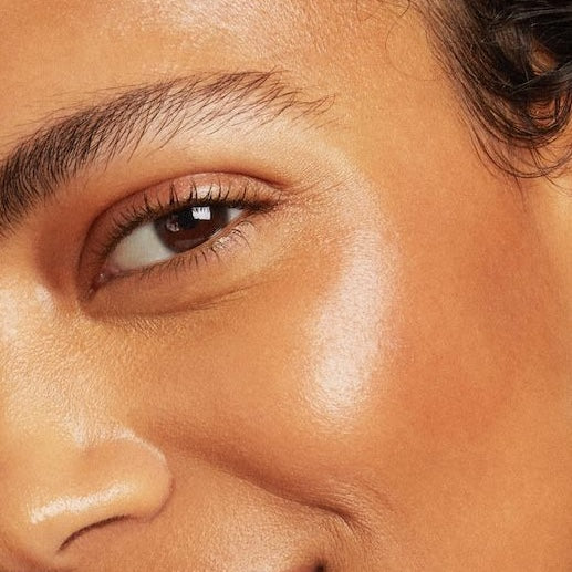 Close-up of a person's eye with a focus on skin texture and color.