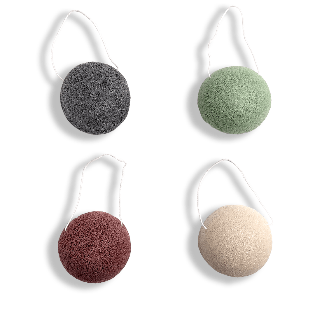 Four konjac sponges with white handles on a transparent background