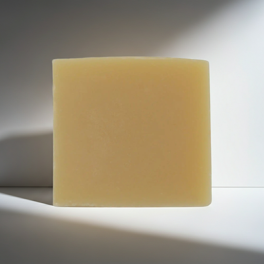 Yellow soap bar on a white background