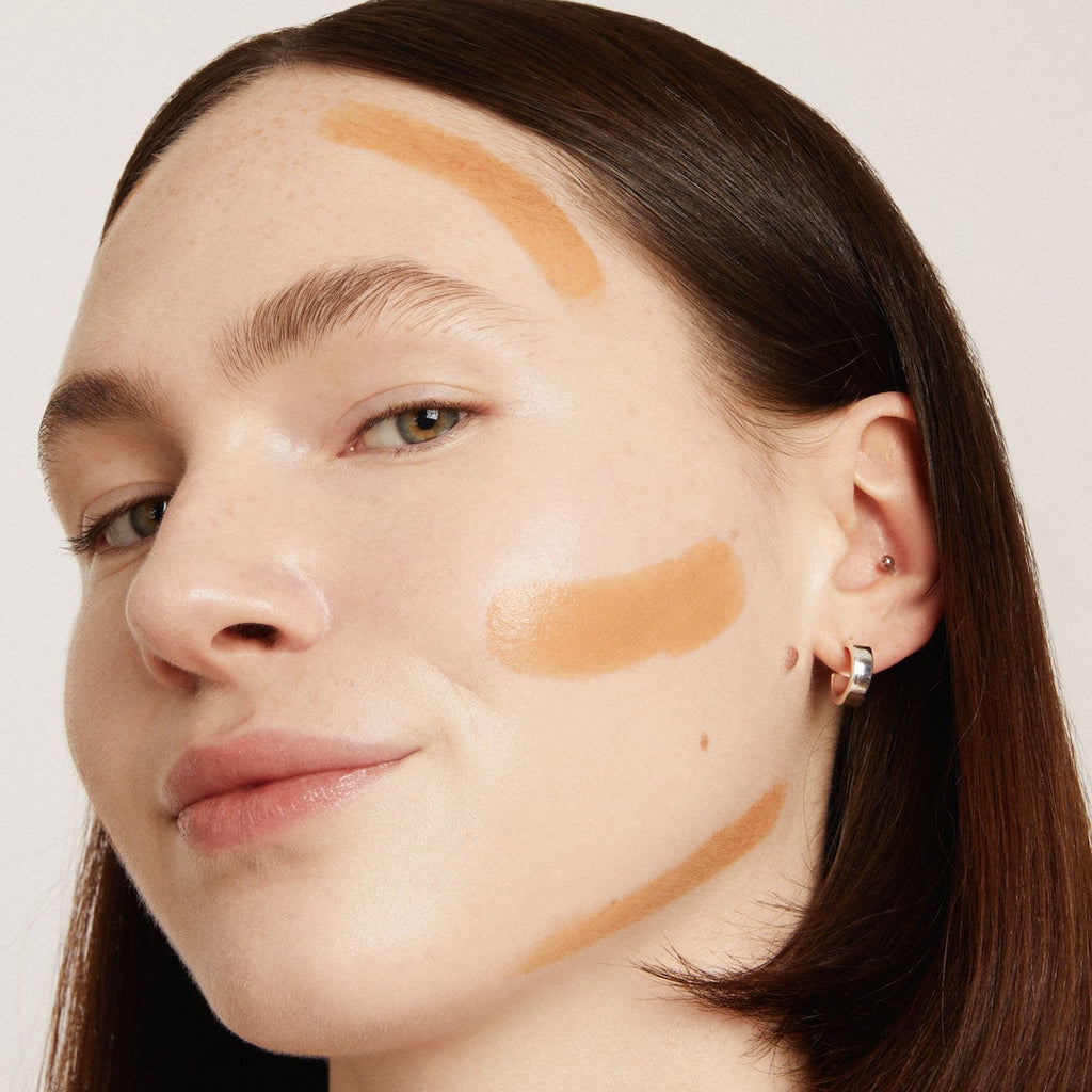 Woman's face with makeup on a neutral background