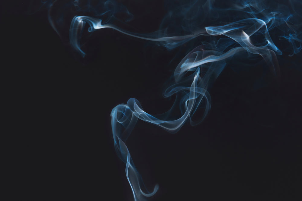 Blue smoke or vapor against a black background