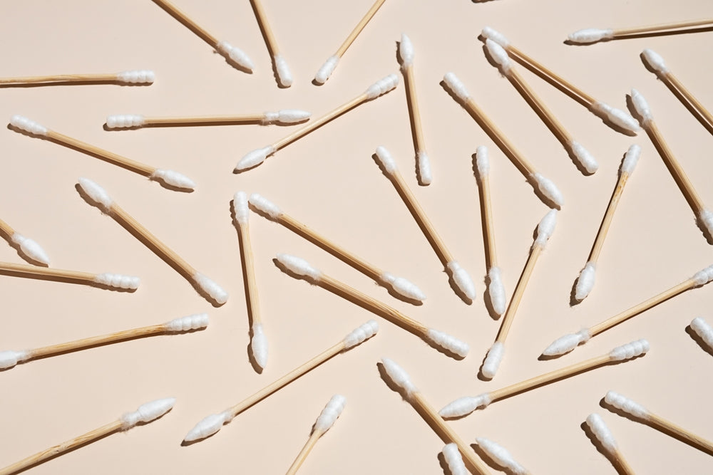 Pattern of bamboo cotton buds on a beige background