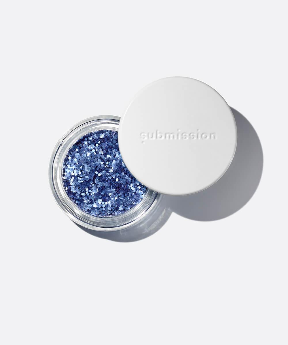 Blue glitter in a open container with 'submission' branding on a white background